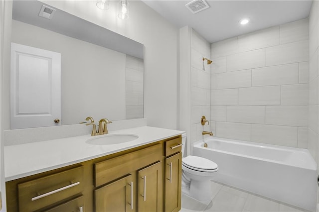 full bathroom with vanity, tile patterned flooring, tiled shower / bath combo, and toilet