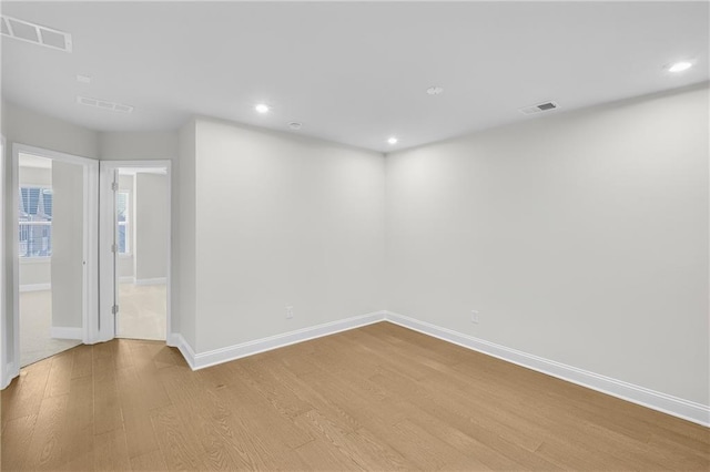 empty room with light hardwood / wood-style floors