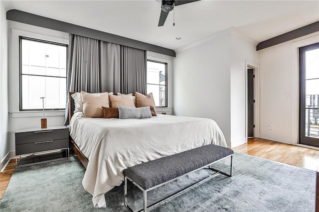 bedroom with light wood finished floors, ceiling fan, and baseboards