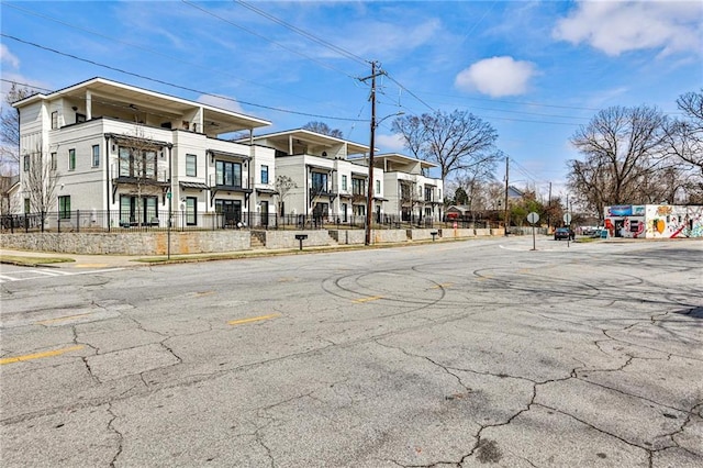 view of street with sidewalks, a residential view, and curbs