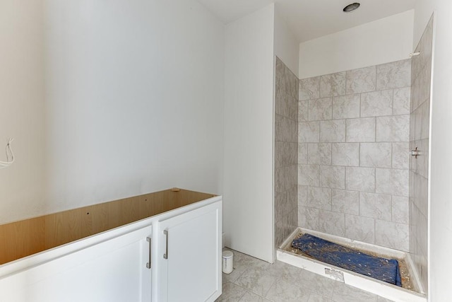 bathroom with tiled shower