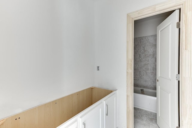 bathroom featuring tile patterned floors and a bath