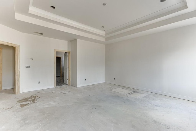 empty room featuring a raised ceiling