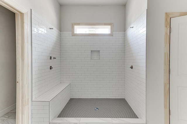 bathroom featuring a tile shower