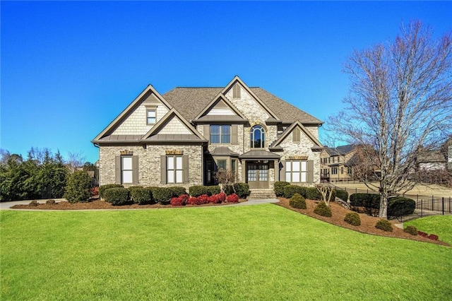 view of front of home featuring brick siding, a front yard, and fence