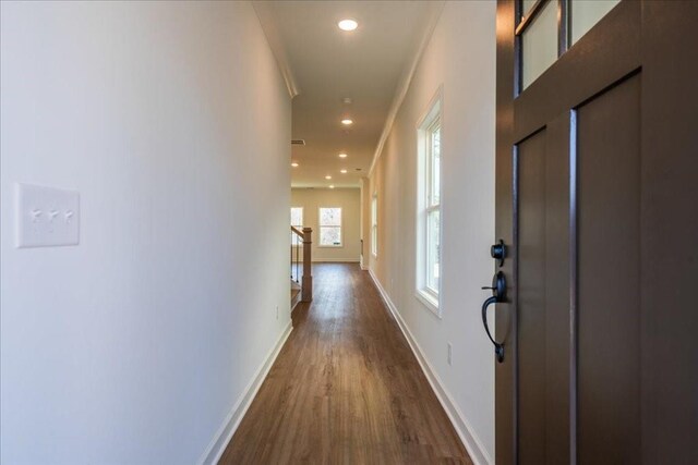 hallway with baseboards, dark wood-type flooring, and recessed lighting