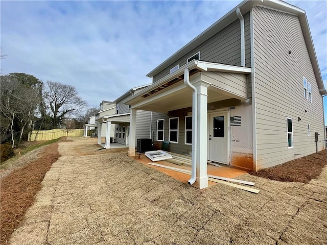 rear view of house featuring cooling unit and a patio area