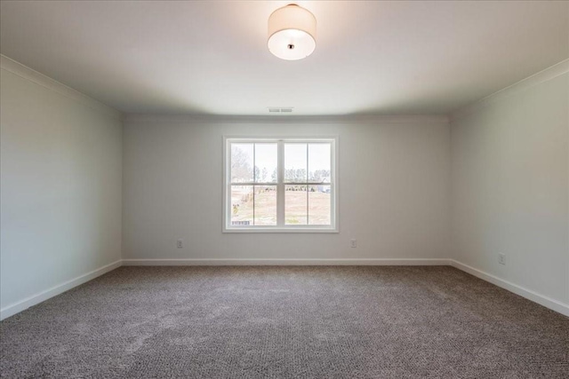 unfurnished room featuring carpet floors, visible vents, baseboards, and crown molding