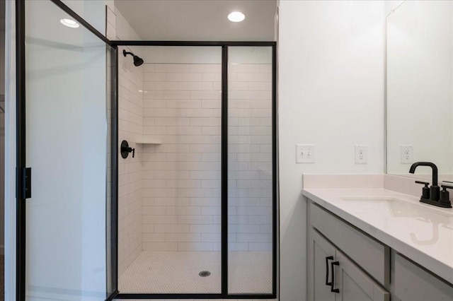 full bath featuring a stall shower, vanity, and recessed lighting