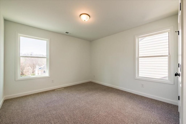 unfurnished room featuring baseboards and carpet flooring