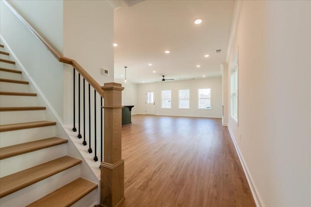 interior space with a ceiling fan, baseboards, wood finished floors, and recessed lighting