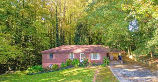 view of front of property with a front yard and a carport