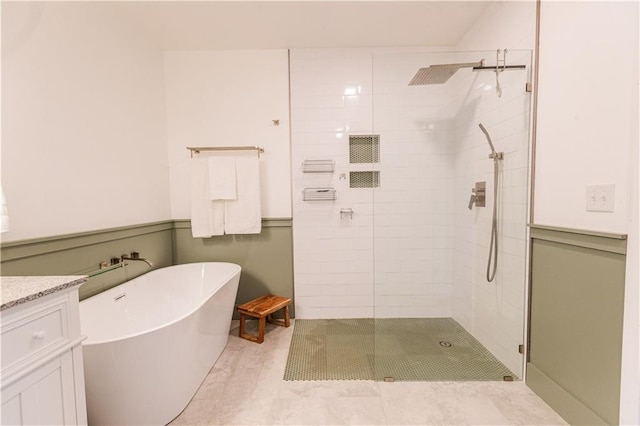 full bath featuring a freestanding bath, a shower stall, and vanity