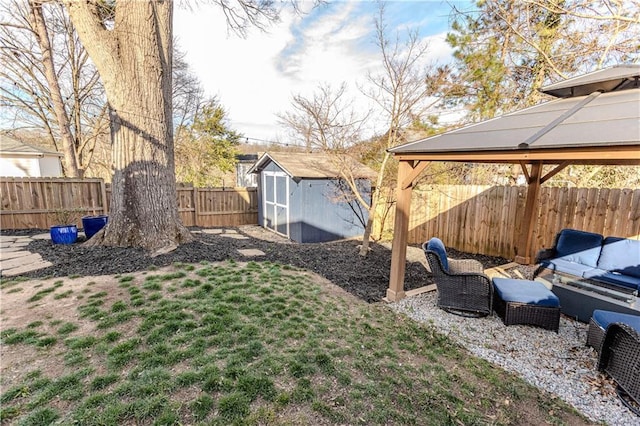 view of yard featuring a fenced backyard, an outdoor structure, a gazebo, and a storage unit