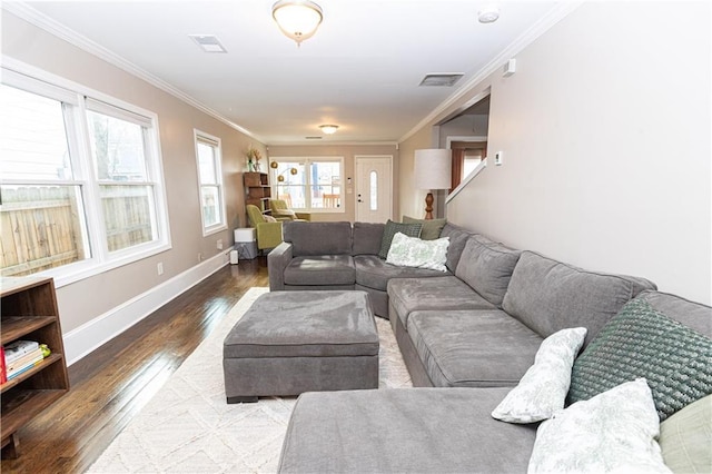 living area featuring visible vents, crown molding, baseboards, and hardwood / wood-style flooring