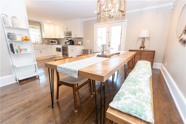 dining room with dark wood-style floors, wine cooler, french doors, crown molding, and baseboards