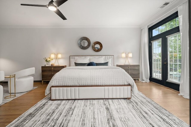 bedroom with crown molding, ceiling fan, and wood finished floors
