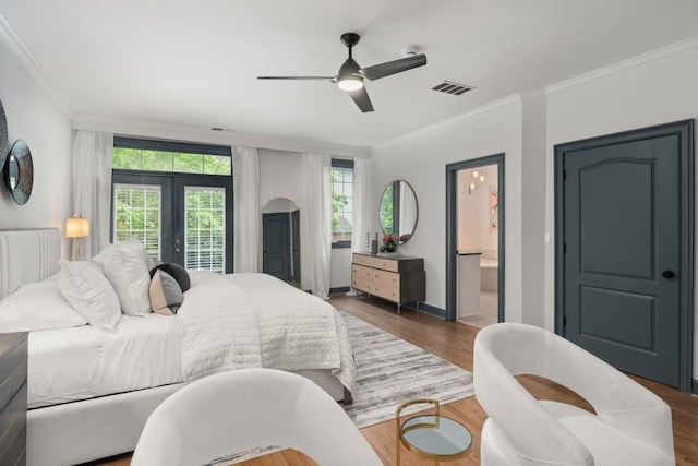 bedroom with access to exterior, french doors, wood finished floors, visible vents, and ornamental molding