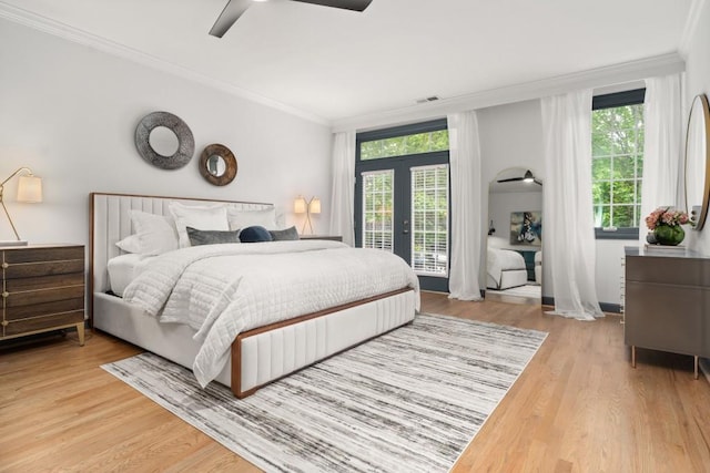 bedroom with multiple windows, french doors, wood finished floors, and visible vents