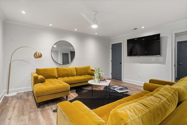 living room featuring ornamental molding, wood finished floors, baseboards, ceiling fan, and recessed lighting