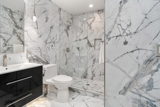 bathroom featuring tile walls, stone wall, vanity, and toilet