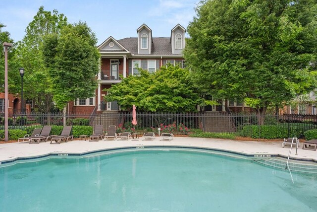 pool featuring a patio area and fence