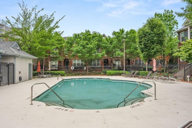 pool with fence and a patio area