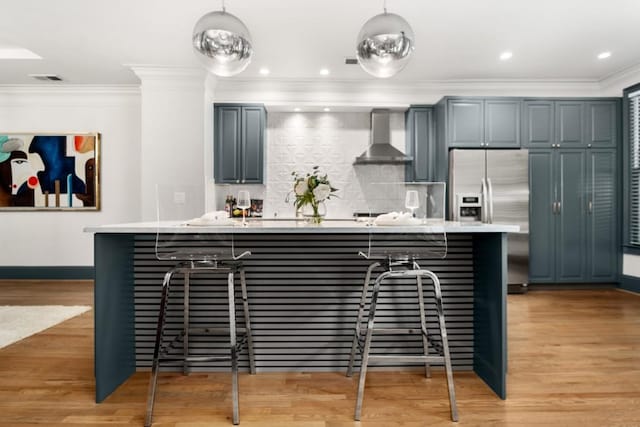 190 Centennial Way, Atlanta, GA 30313 - kitchen with stainless steel refrigerator with ice dispenser, wall chimney exhaust hood, light countertops, a kitchen bar, and ornamental molding