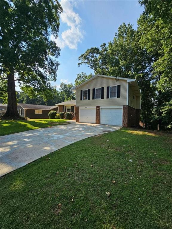 view of front facade with a garage and a front lawn