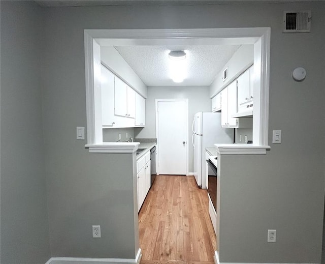 3020 Wingate Way, Sandy Springs, GA 30350 - kitchen with a textured ceiling, light wood-style flooring, under cabinet range hood, visible vents, and white cabinets