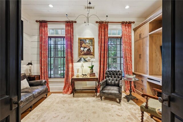 living area with hardwood / wood-style flooring and plenty of natural light