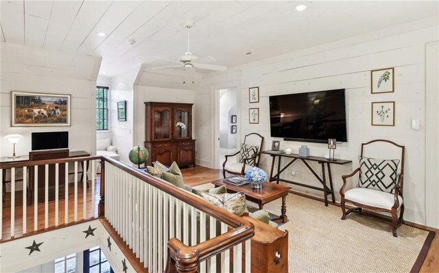 living room with light hardwood / wood-style floors and ceiling fan