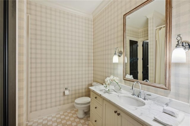 bathroom featuring toilet, vanity, and crown molding