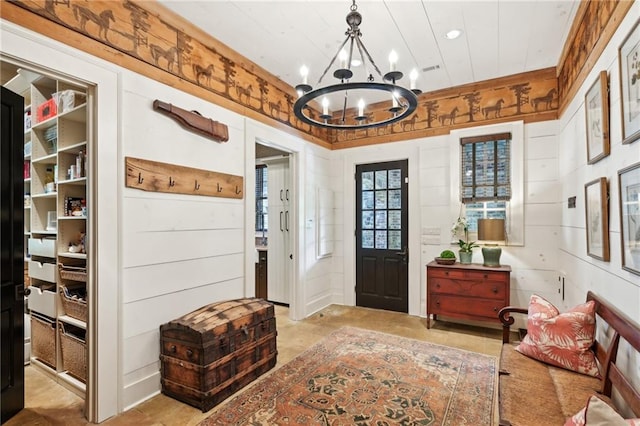 foyer entrance with a notable chandelier