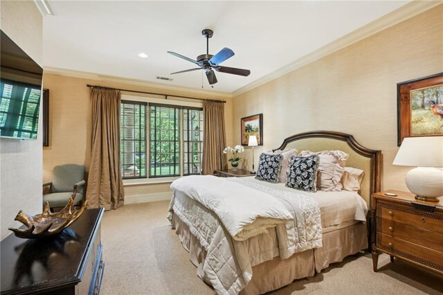 carpeted bedroom featuring ceiling fan and crown molding