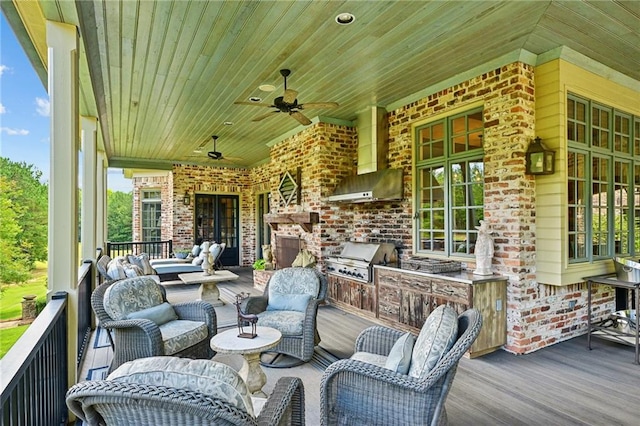 wooden terrace with outdoor lounge area, an outdoor kitchen, a grill, and ceiling fan