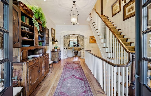 foyer with light hardwood / wood-style flooring and a chandelier