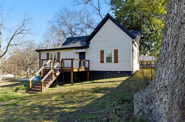 back of property featuring stairway, crawl space, a lawn, and a deck