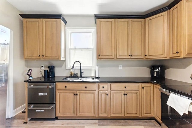 kitchen with a sink, dark countertops, electric range oven, and light brown cabinetry