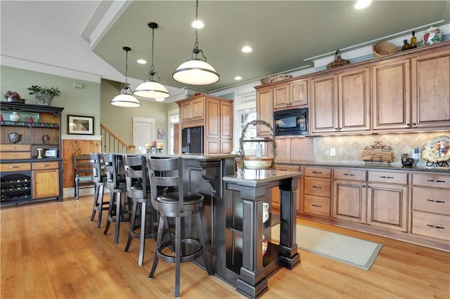 79 Strawberry Way, Jasper, GA 30143 - kitchen with black appliances, ornamental molding, light wood-style flooring, backsplash, and an island with sink