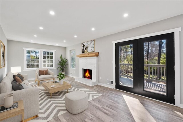 unfurnished living room featuring a fireplace, recessed lighting, light wood-style floors, and baseboards
