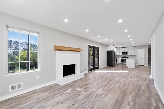 kitchen featuring a sink, tasteful backsplash, appliances with stainless steel finishes, and wood finished floors
