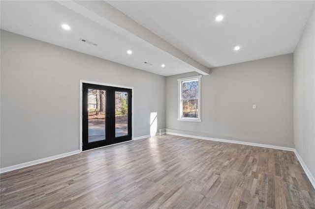spare room with visible vents, baseboards, recessed lighting, and wood finished floors
