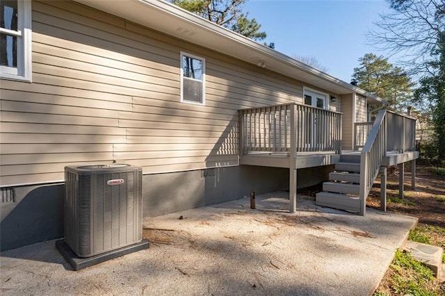 rear view of house featuring crawl space, a deck, and central AC