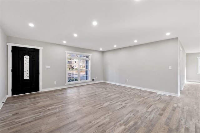 entryway with recessed lighting, light wood-style flooring, and baseboards