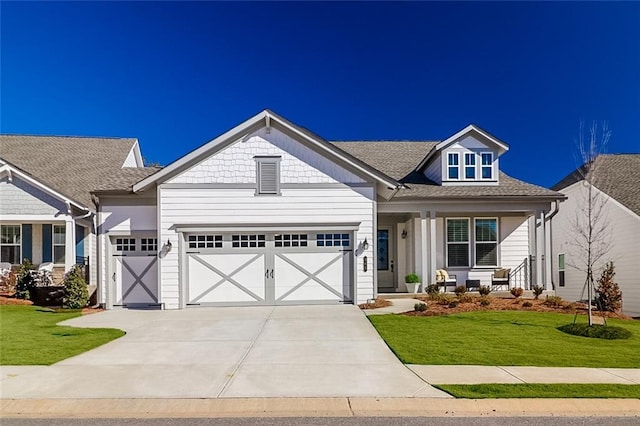 craftsman-style home with a garage, a porch, and a front yard