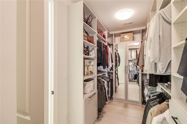 spacious closet featuring light hardwood / wood-style floors