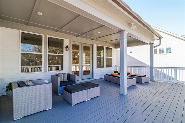 wooden deck featuring an outdoor living space and french doors