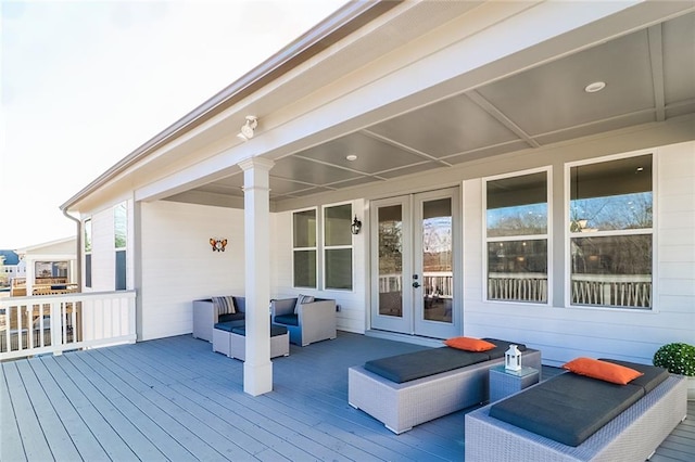 wooden terrace with french doors and outdoor lounge area