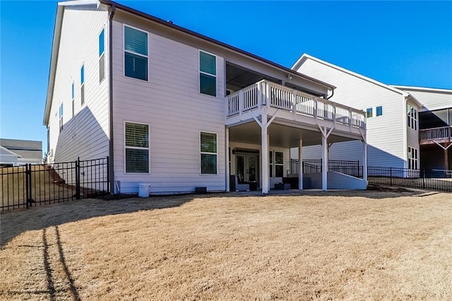 rear view of house featuring a lawn